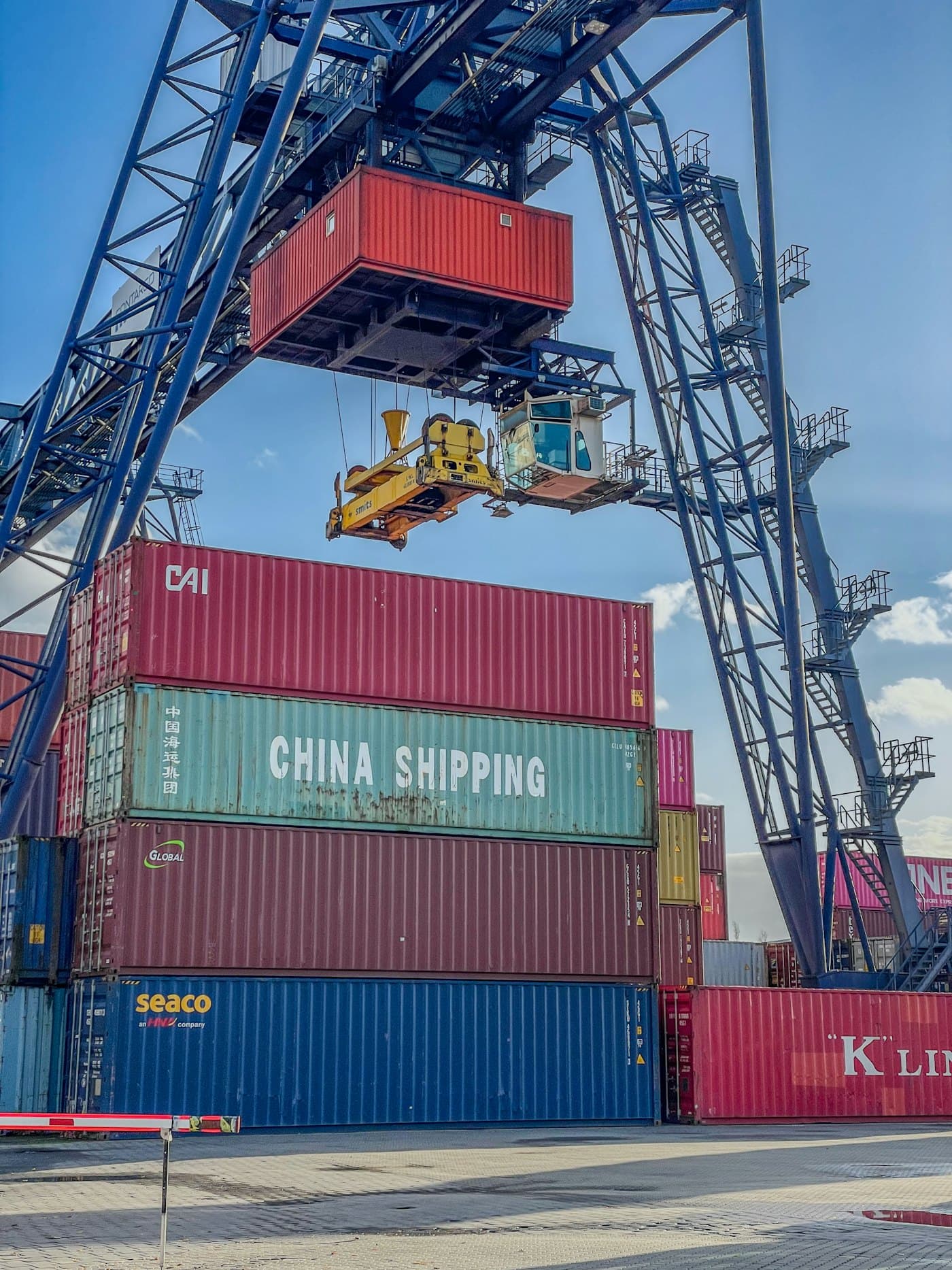 A port crane lifting a shipping container